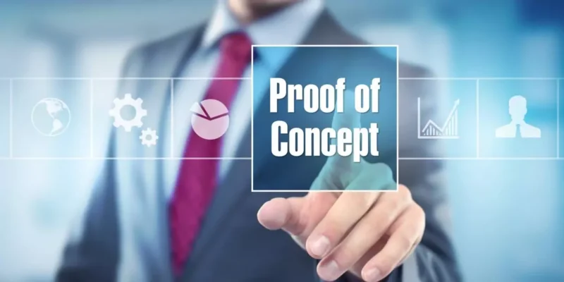 Businessman pointing at a Proof of Concept touchscreen display with business icons