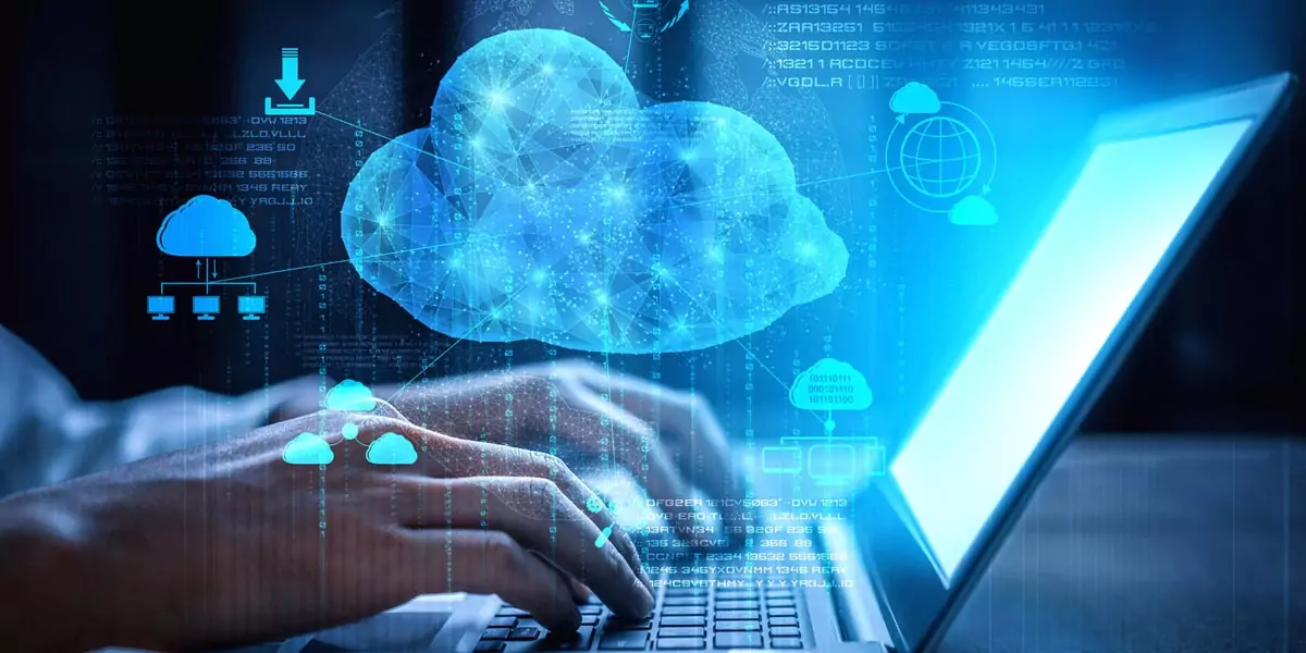 Hands typing on a laptop with glowing cloud computing network icons overlay
